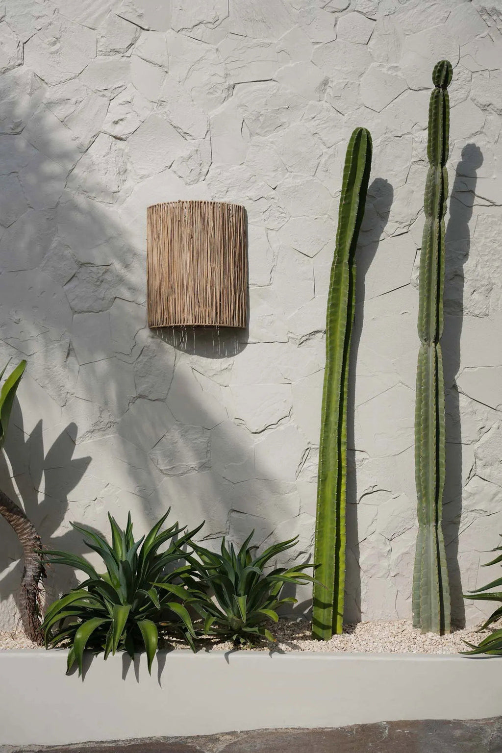 Cylindrical woven wall applique on a white background