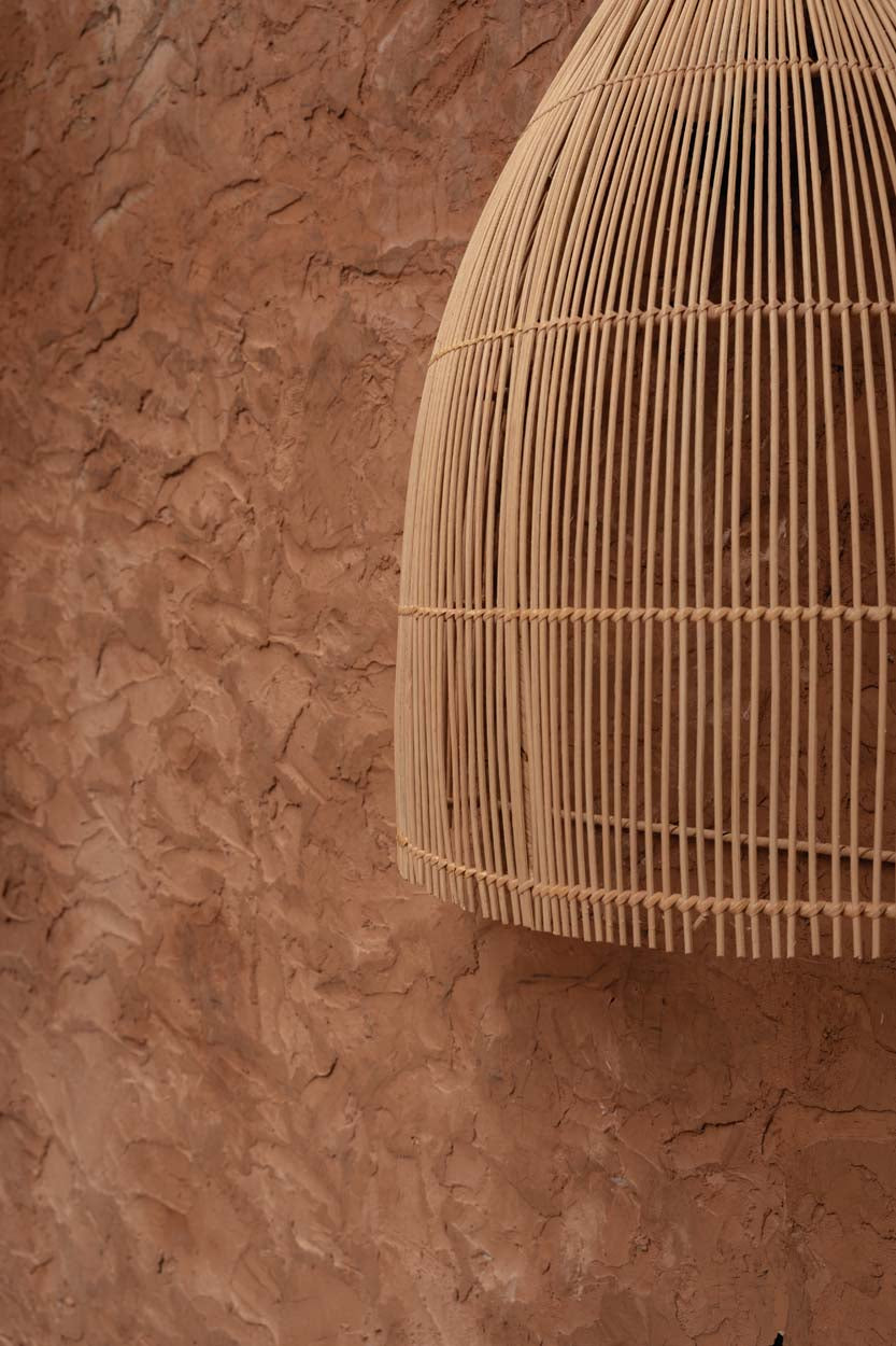 Woven rattan lampshade on a white background